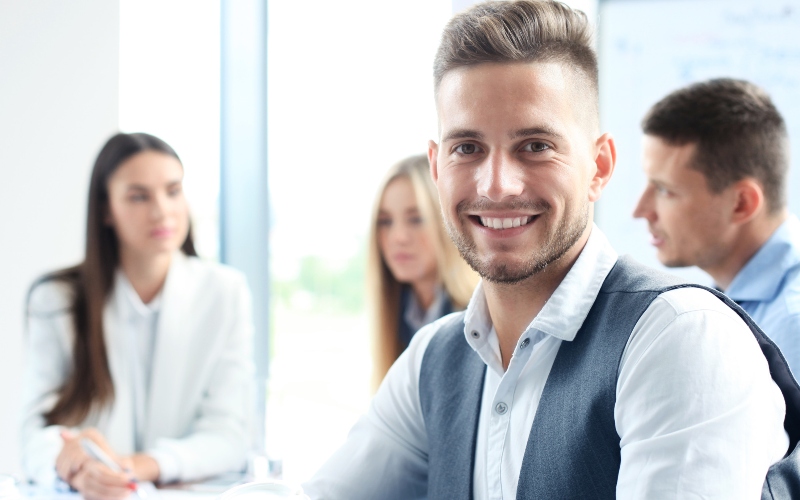 businessman with colleagues in the background in office
